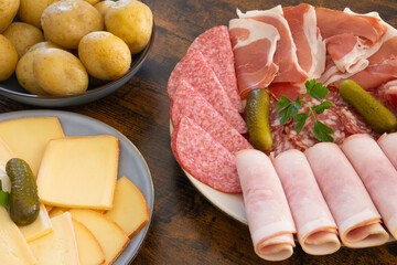 plate of charcuterie cheese for a raclette on a table