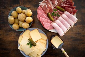 plate of charcuterie cheese for a raclette on a table