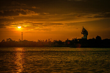 Sunset river landscape in Thailand with Naka God of Snake Statue 