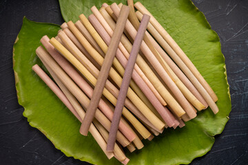 Fresh Lotus stem in lotus leaf on black background, Lotus stem variety of food ingredients.