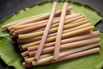 Fresh Lotus stem in lotus leaf on black background, Lotus stem variety of food ingredients.