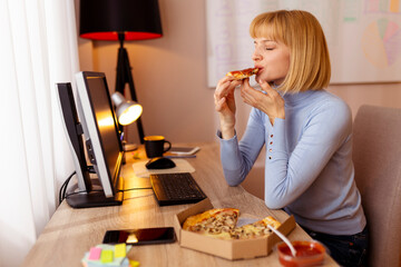 Woman taking a lunch break eating pizza