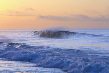 beautiful waves and clouds on the ocean shore 