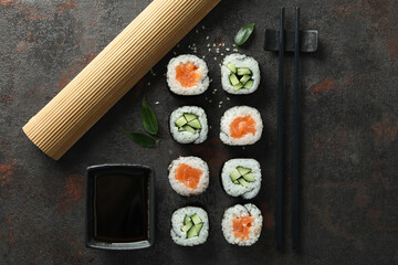 Concept of tasty food with maki on dark textured background © Atlas