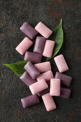 Chewing or bubble gum on dark textured background