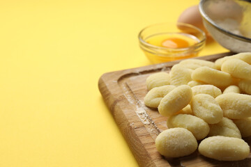 Concept of cooking with raw potato gnocchi, space for text