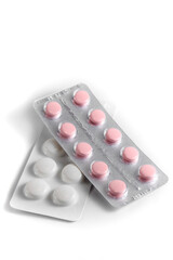 Close-up of a couple white pills or capsules on isolated white background.