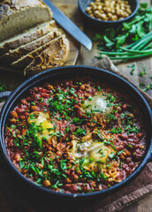 Shot of shakshouka dish bread and garnish