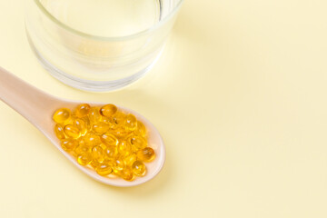 Close up of  oil filled capsules on spoon suitable for: fish oil, omega 3, omega 6, omega 9,  vitamin A, vitamin D, vitamin D3, vitamin E - Image