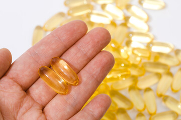 Close up of  oil filled capsules suitable for: fish oil, omega 3, omega 6, omega 9,  vitamin A, vitamin D, vitamin D3, vitamin E - Image