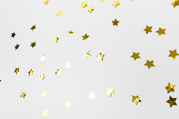 golden confetti on white background flat lay text place .