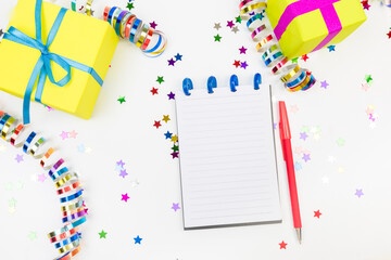 Festive decorations and notebook with wish list on white background , flat lay . Planning concept. - Image