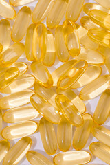 Close up of  oil filled capsules suitable for: fish oil, omega 3, omega 6, omega 9,  vitamin A, vitamin D, vitamin D3, vitamin E - Image