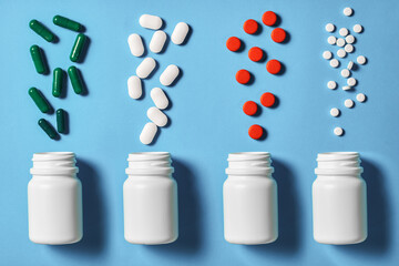 different forms of pills are poured from vials. Variety of appearance of drugs. Top view