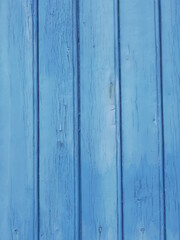 Naklejka premium A close-up on a blue wooden door. Solesmes, France, december 2021.