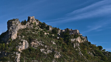 Fototapeta na wymiar Beautiful view of historic village Eze located on a rock at the French Riviera on sunny day with old buildings and historic castle ruin.