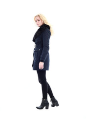 full length portrait of blonde woman wearing long winter coat. and casual clothes. standing pose, isolated on a white studio background.