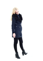 Fototapeta premium full length portrait of blonde woman wearing long winter coat. and casual clothes. standing pose, isolated on a white studio background.