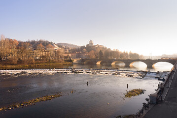 Turin, Italy. February 15, 2022. View on Po River and Vittorio Emanuele I Bridge on the late afternoon.