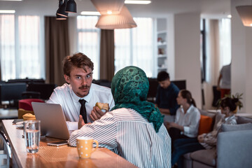 International multicultural business team.A young business man and woman sit in a modern relaxation space and talk about a new business.