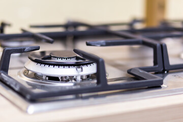 Gas stove burner close-up on a blurred background