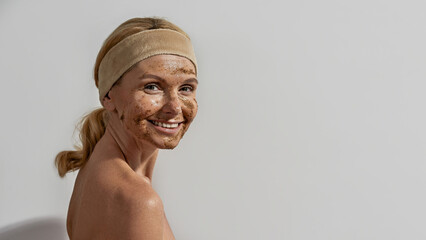 European woman with coffee and salt scrub on face