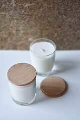 Two handmade natural soy or coconut candles in glass cups on. crackling wick. natural