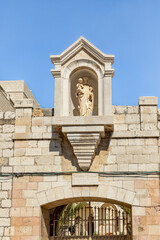 Religious stone statue above the gate of the Christ Anglican Church on 6166 street near the Church Of Annunciation in Nazareth, northern Israel