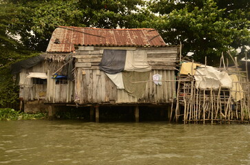 A floating house while sailing the Mekong river delta. Different Vietnam images, streets, markets, rivers, beaches, and national parks.