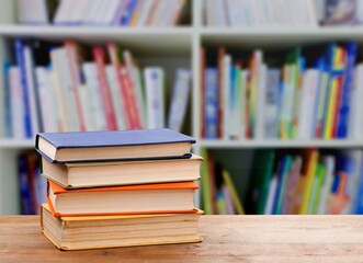 Stack of books on the table in the library background