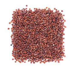Red quinoa seeds isolated on white background. Pile of raw kinwa. Top view.
