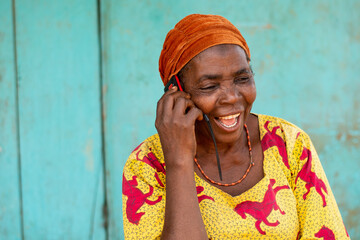 excited elderly african woman making a phone call