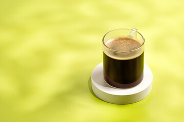 One glass coffee cup with espresso in morning on podium and green background. Aroma, ristretto. Mug of coffee.
