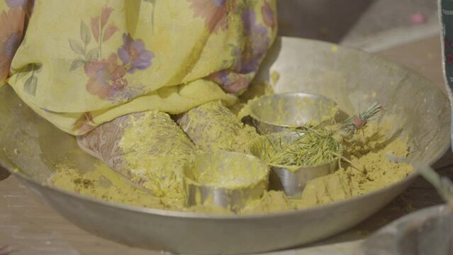  Turmeric is being applied in the hands of the bride in India called as Haldi Ceremony. An Indian wedding tradition.