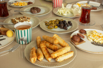 Classic Turkish home breakfast. Cigarette pastry (in Turkish ''sigara boregi'') , cheeses, olives, eggs, sausage, black tea.