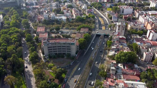 Tilt Down Shot of Viaducto and Rio Becerra Avenues, with an Abandoned Building at the Junction and a Part of the Escandon Colony on the Right