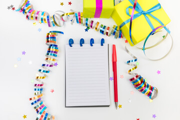 Festive decorations and notebook with wish list on white background , flat lay . Planning concept. - Image