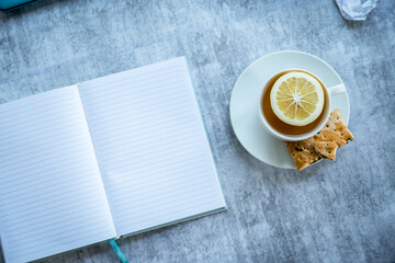 notepad and cup of tea, freelance work. home office, education or writing concept