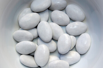 Close up of a group of Candies with white chocolate, cocoa chocolate and thin vanilla-coated sugar coating. A delicious choice for wedding sweets. White dragees