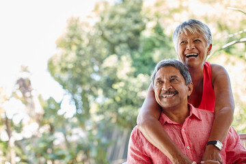 Never stop playing. Shot of a carefree senior couple enjoying a piggyback ride outdoors.