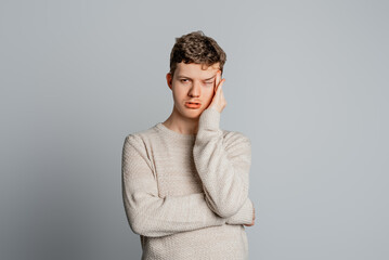 Young man wearing casual clothes who is bored, fatigued and need a relax day, looking tired and...