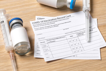 Fototapeta premium Syringe and vaccine vial for corona virus are on medical form required for travel and tourism. - Image