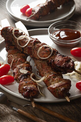 Turkey kebab on skewers with pickled onions and cherry tomatoes