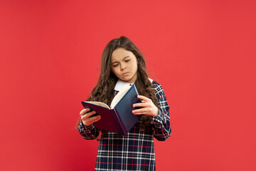 serious teen girl read book. child holding copybooks. concept of knowledge and wisdom.