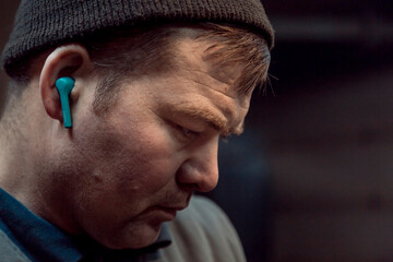 Portrait of a welder with a microphone in his ear at the workplace