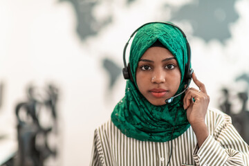  Muslim female with green hijab scarf customer representative business woman with phone headset helping and supporting online with customer in modern call centre