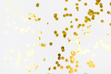 golden confetti on white background flat lay text place .