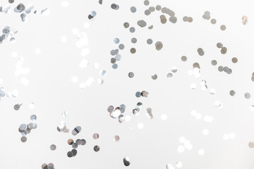 round silver confetti on white background flat lay text place .
