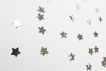 star silver confetti on white background flat lay text place .