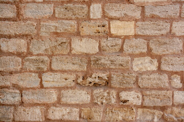 Antique masonry from old blocks and mortar. Horizontal photo.